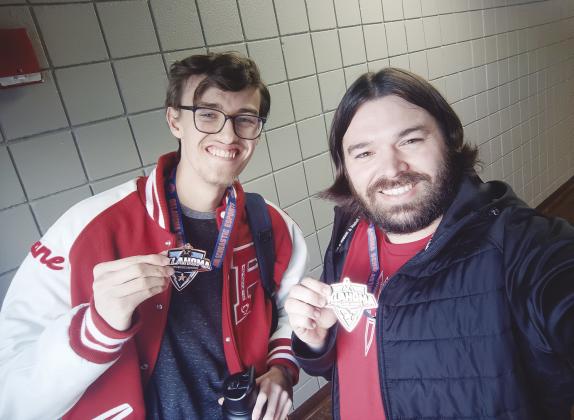 Prague High School student Shane Newman, left, stands with coach Noah Stelzer, showing off medals from Smash Bros State competition. Smash Bros is just one of the games that the PHS esports team competes in. Photo/Noah Stelzer