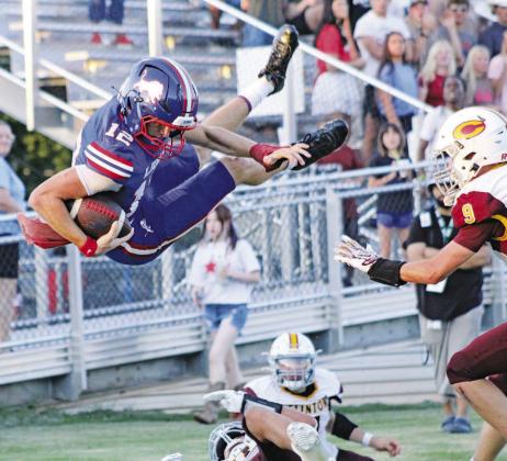 Chandler quarterback Clayton Ritchie goes airborne for a touchdown during the Lions’ game against Clinton Friday night. Ritchie’s 18-yard run on third down tied the score at 7-7 in the second quarter. Photo/Landon Gray