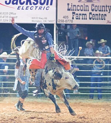 Top, Grant Elerick from Stroud, the Jim Thorpe High School Football Player of the Year. Photo/Chelsea Weeks. Above, Trey Ireland, the bull-riding winner at the Chandler rodeo. Photo/Brian Blansett. Right, Joe Ready and Jerred Monroe weighing a catfish at the fourth annual Sinkin Teeth noodling tournament. Photo/ Chelsea Weeks.