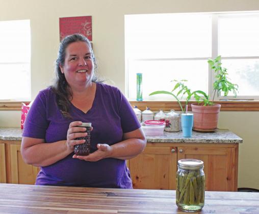 Michelle Hong and some of her jam and pickled okra. Photo/Lily Huff