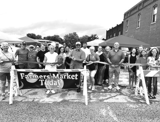 Venders, visitors and members of the Chandler Area Chamber of Commerce gather at the ribbon-cutting for the Chandler Farmers Market on June 6. The market runs every Saturday from 8 a.m. to 11 a.m. on Eighth Street next to the courthouse. Photo/Emily Kalka