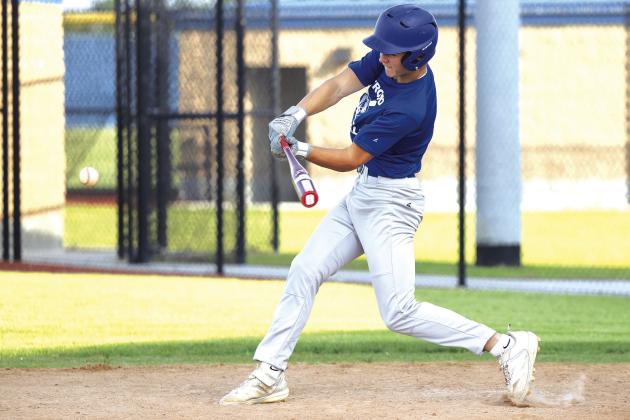 Gideon Smalley lines up for the hit in a summer ball game against New Kirk. Photo/Beth Young