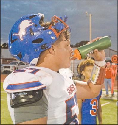 Senior lineman Chaden Sullivan stays hydrated during a first-half timeout at Poteau. Photo/Brian Blansett