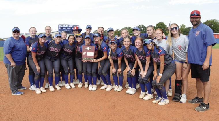 Above, the Chandler Lady Lions pose with their Super Regional championship plaque after earning their spot in the Class 3A state tournament last Thursday. The Lady Lions will face Lindsay at 10 a.m. Thursday at the Hall of Fame Stadium complex. At right, Hadlee Massengale slides home safely with the only run in Chandler’s 1-0 first-game victory. Photos/Brian Blansett