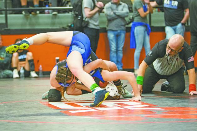 The referee takes a close look as Chandler’s Lizzy Pryor gets close to pinning Newcastle’s Topanga Bornt (head on mat) during the ‘89er Showdown in Lexington last week. Pryor was 3-0 at the tournament to win her weight class and is 12-1 for the season. The Lady Lions are traveling to Union High School for the Supergirl 64 and the boys and girls will wrestle at Mannford Monday. Photo/Jennifer Pryor