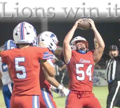 Chandler senior Landon Massie holds the ball aloft after recovering a fumble in the second half Friday night. Photo/Brian Blansett