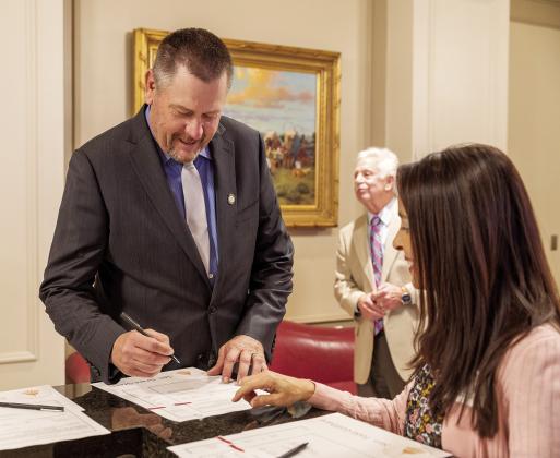 State Sen. Grant Green, R-Wellston, signs his oath of office on Statehood Day at the Capitol.