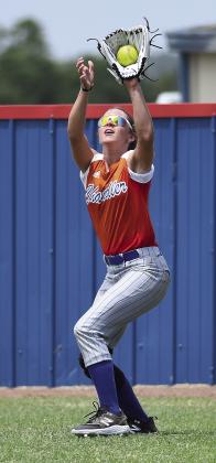 Top, from left, Meeker Lady Bulldogs Emma Janway, Rylee Standlee, Hazel Wahpepah and Maddasyn Davis warm up facing the morning sun during practice last week, Right, Chandler’s Jaylee Ventriss brings in a fly in left field and, above, Meeker sophomore Layla Carter throws to first. Fastpitch season starts Aug. 7. Photos/Brian Blansett