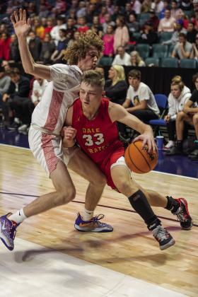Above, the Dale bench celebrtates a three-pointer during the Pirates’run to the championship of the Tournament of Champions in Tulsa between Christmas and New Year’s. Right, tournament MVP Dayton Forsythe drives the baseline. Photos/Rick Hester