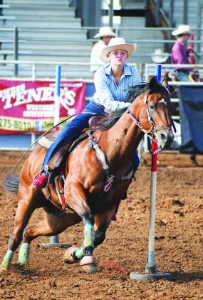 Above, Lexi Helmick of Meeker throws a loop during breakaway roping Sunday night at the International Finals Youth Rodeo in Shawnee. The rodeo continues through Friday night with the championship short go-around. Right, Marley Miller from Chandler heads her horse to the timer line during pole-bending competition in the Monday morning performance Below, bareback bronc rider Blake Huddleston from McLoud comes out of the chute on his bronc Sunday evening. Photos/Brian Blansett