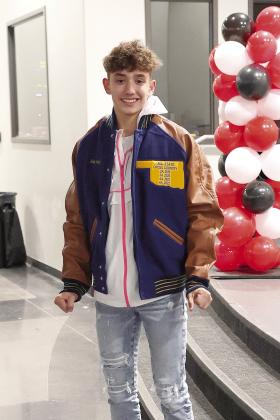 North Rock Creek senior Jordan Coody tries on his All-State jacket recently. Coody has the distinction of being an All-State runner in three different classes as North Rock Creek’s enrollment has increased. He made it in Class 2A as a freshman, Class 3A as a sophomore and in Class 4A the last two years. Photo/Sheryl Gowin