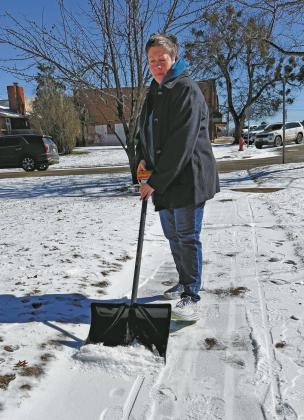 Deanna Trippler of Chandler took advantage of warmer temperatures on Friday to shovel and scrape the ice from her sidewalk. Photo/Brian Blansett
