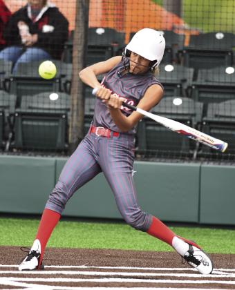 Prague’s Liyah Dauman, shown here batting in the regional tournament, has an extra full week. She’s play in the Class 4A state tournament on Wednesday with the Lady Devils softball team, then compete in the long jump in the Class 3A state track meet at Ardmore. Photo/Brian Blansett