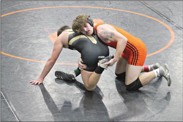 Kyle Hobill (orange singlet) wrestles Dalton Diacon of Inola in the first round of the regional tournament in Vinita last weekend. Hobill won, 4-3. Photo provided