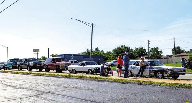 A group of participants from Chandler hang out next to Shane Massie’s station wagon while waiting for the Route 66 Capital Cruise. Photo/Jennifer Pryor