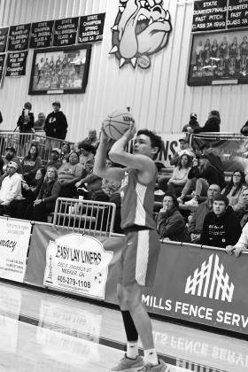 Above, Damian Matlock rifles in a three-pointer for McLoud in the Redskins’ season-opening win over Meeker. Photo/Brian Blansett Right, Aiden Hessman (13) gets up a shot for Meeker against Wellston. Photo/Brian Blansett Below, the Dale cheerleaders in their pre-game routine. Photo/Rick Hester. Bottom, North Rock Creek’s Olivia McRay hits the deck for a loose ball in the Lady Cougar’s win over Dickson. Photo/Sheryl Gowin