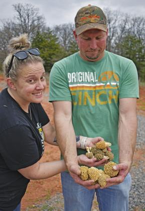 Charla Munn and Chris Cole, Chandler residents, hold some of the 95 morels they foraged on Sunday, Mar. 31, on their property. The two have been hunting morels since they were children and go out as much as they can during the short morel season. Photo/Emily Kalka