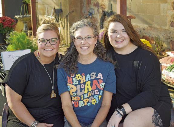 From left to right are Carlee Milehan, Janna Collins and Kelly Lee. The three women work at The Honey Pot, which recently won the bid for the Downtown Beautification Project launched by the City of Chandler. They will put up planters from City Hall down to 11th Street and maintain them throughout the year. Photo/Emily Kalka