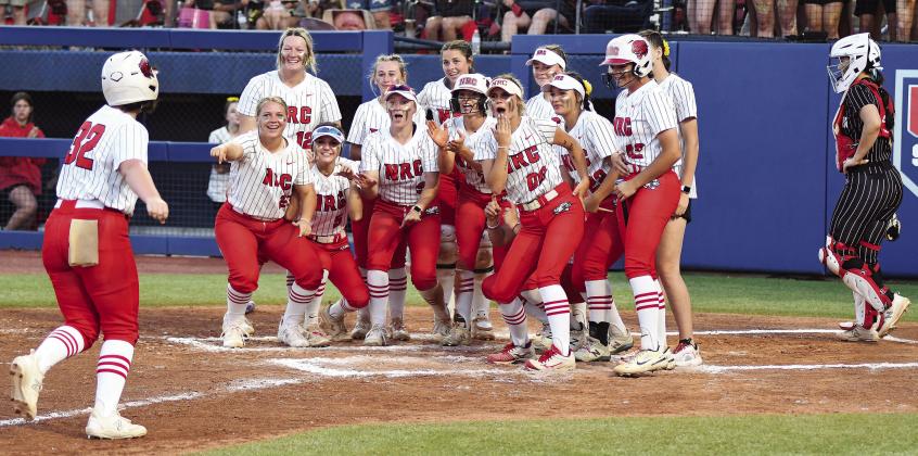 Above, Caty Baack heads to a home-plate welcome after homering in North Rock Creek’s state championship win over Washington. Below, sophomore Morgan Campbell turns a would-be home run into an out in the Lady Cougars’ state semifinal win over Tecumseh. Photos/Brian Blansett
