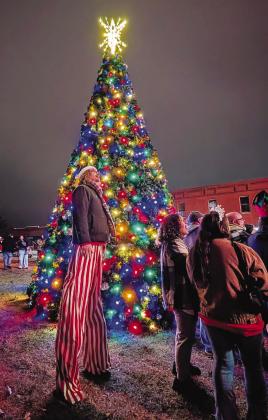 Tate Monroe (on stilts) and other residents watch fireworks on the Lincoln County Courthouse lawn Saturday night during Chandler’s Christmas parade and tree-lighting festival. Santa and Pistol Pete took photos with children, and a Christmas market was held in the Lincoln County Museum of Pioneer History. There were also food trucks and gingerbread house-building in the courthouse. For more photos, see page 1B. Photo/Jennifer Pryor