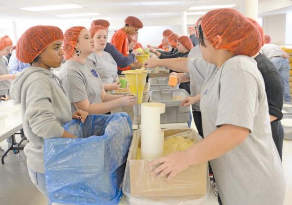 Chandler students build meals for Stamp Out Starvation. Photo/Brian Blansett