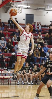 Easton Edmonson flies in for the layup during topranked Dale’s district romp over Mounds. Photo/Rick Hester
