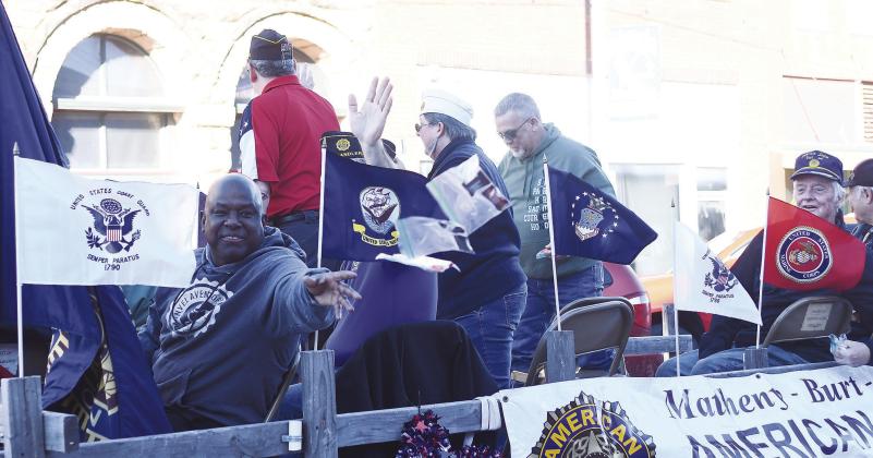 veterans on the American Legion Post No. 64 float throw candy to the crowd during the Chandler Veterans Day parade. Photo/Brian Blansett.