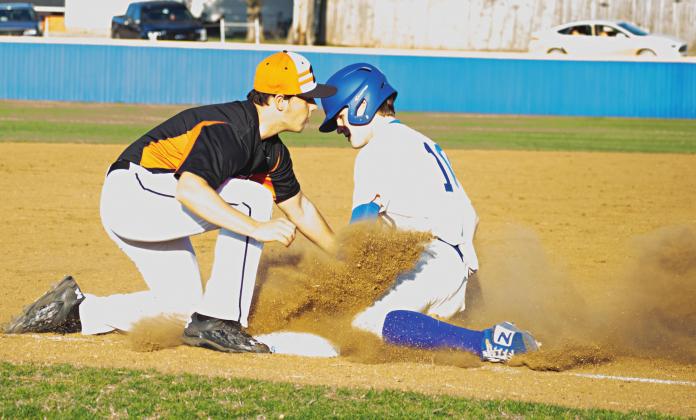 Pictured above, Grant Elerick slides safely into third base.