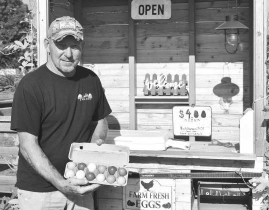 Meeker resident Kenneth Whitaker stands in front of his self-service egg stand near 990 Road and Highway 177. He’s been selling eggs there for about five months. Photo/Emily Kalka