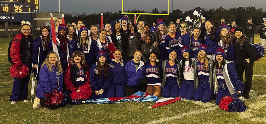 Above, Carson Clagg blots through a hole on one of his 31 carries Friday night at Star-Spencer. Photo/Brian Blansett Right, the Star-Spencer cheerleaders crossed the field before the game with a bag of Halloween candy to share with the Chandler cheerleaders, pom team and band. Photo/ Cynthia Snider