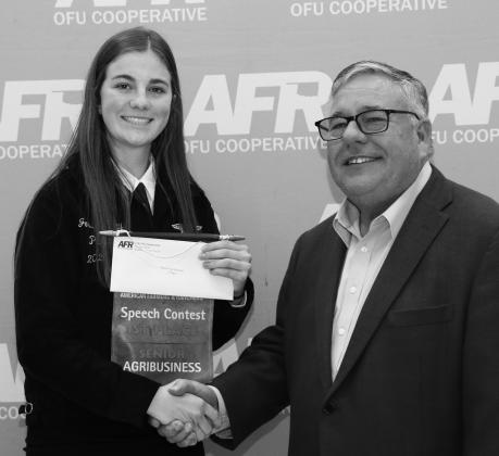 Wellston senior Josie Murray (right) shakes hands with Scott Blubaugh, president of the AFR/OFU after winning first in her speech category on Nov. 11. Murray was entered in Senior Agribusiness and will compete at the state level. Photo/AFR