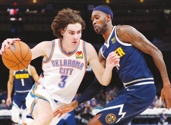 Oklahoma City Thunder guard Josh Giddey drives to the basket against Denver Nuggets forward Will Barton during the second half at Paycom Center. (Alonzo Adams-USA TODAY Sports)