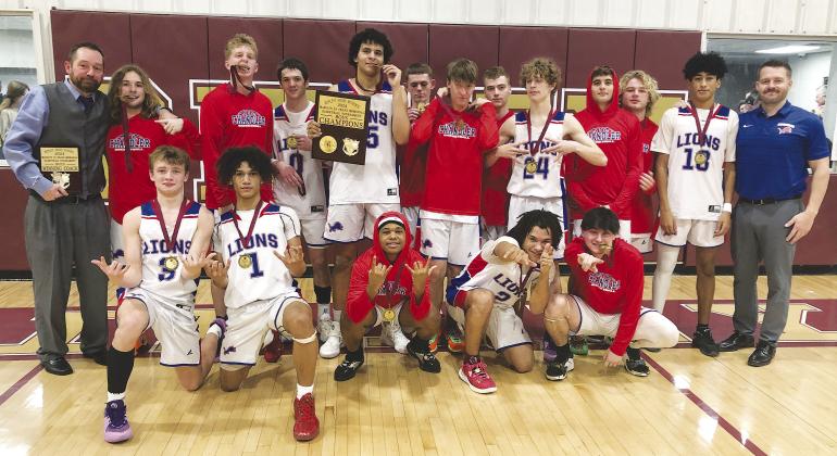 The Chandler Lions pose after winning the Ripley tournament Saturday night. The Lions beat the host Warriors, 50-45. Also winning championships on Saturday were the Wellston Lady Tigers at Davenport, the McLoud boys at Henryetta and the North Rock Creek boys at Konawa. For more, see Page 1C. Photo/Brian Blansett