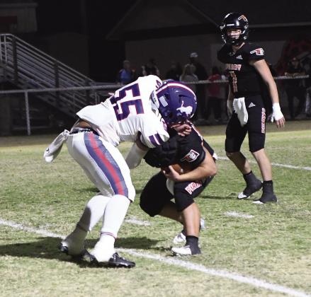 Chandler’s Travian Tillis (55) provided the visual metaphor for the game Friday when he steer-wrestled Sperry’s ballcarrier to the ground for a loss in the backfield. Photo/Brian Blansett