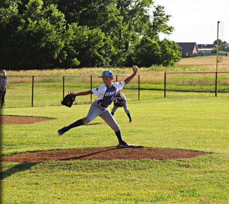 Pictured above, Gideon Smalley pitches the ball to home plate. Pictured to the left, Mason Eversole slides into third base. Photos/JudyBukowski.