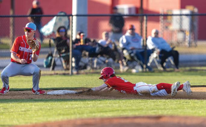 Easton Edmonson slides safely into third on the steal during the game against Chisholm. Photo/Rick Hester