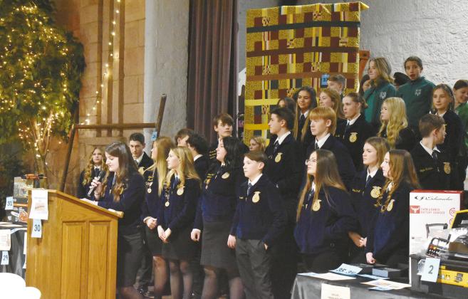 Junior Katie Wright, treasurer of the Chandler High School FFA chapter, welcomes guests to the Second Annual Chandler Ag Booster Club Dinner and Auction on Jan. 25 at the Route 66 Interpretive Center. Over 40 lots were up for grabs in the live auction, with more items in the silent auction. The money was raised to help support Chandler FFA and 4-H students with scholarships, trips, activities and more. Photo/Emily Kalka