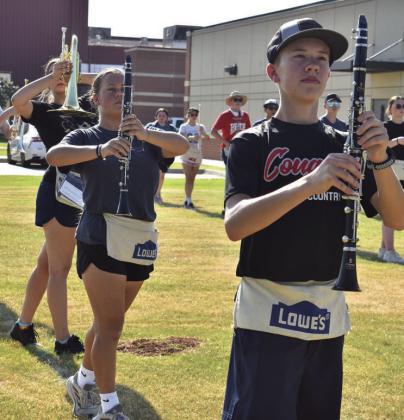 On the left, members of the North Rock Creek marching band work through the basics of marching on Aug. 3 during their band camp. The band’s show this year is “Caged.” On the right, the Spirit of Stroud marching band works through steps at their band camp. The band’s show this year is “Eye of the Hurricane.” Photos/Emily Kalka