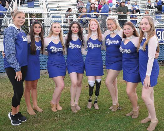 Stroud freshman Sierra Wade, above left, dances during the Stroud High School pom team’s halftime performance and, above right, poses with her teammates before the football game. Photos/Brian Blansett