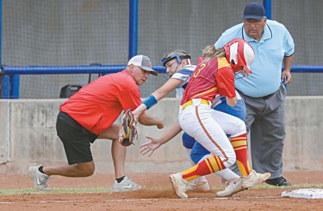 Stroud third baseman Makenna Hall takes a throw as Dale’s Emmie Idleman gets back to the base during the state semifinals last week. Looking on are Dale coach Andy Powell and The Blue. Photo/Rick Hester