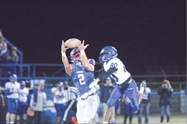 Friday night was the last time for brothers Dylan Mahan, Braxen Burnes and Darian Mahan to suit up together in a regular season game. Above, Dylan, a senior, goes for a pass in the Lions’ win over Holdenville. Photo/ Braden Wade