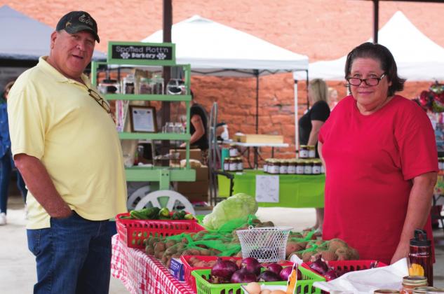 Pictured above, Eldon Gordon and his sister, Darlene Grammer, stand by her table as the Stroud Farmers Market opens.