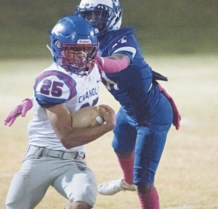Above, Chandler’s Casmen Hill stiff-arms a Millwood defender during a long run Friday night. Above left, Darian Mahan collects a touchdown pass. Photos/Brian Blansett
