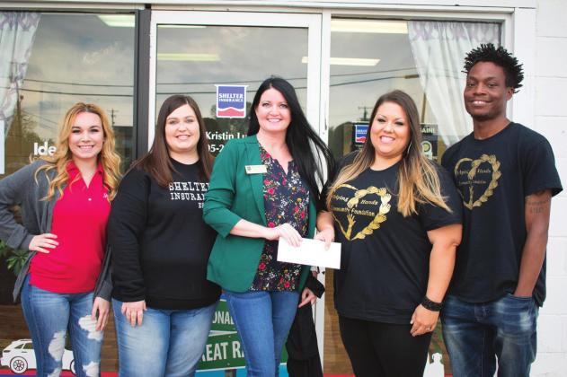 Pictured from left to right, Alyssa Ludi, Lean Elliot and Kristin Ludi present the donation to Sabra and Thomas Denson, founders of Helping Hands.
