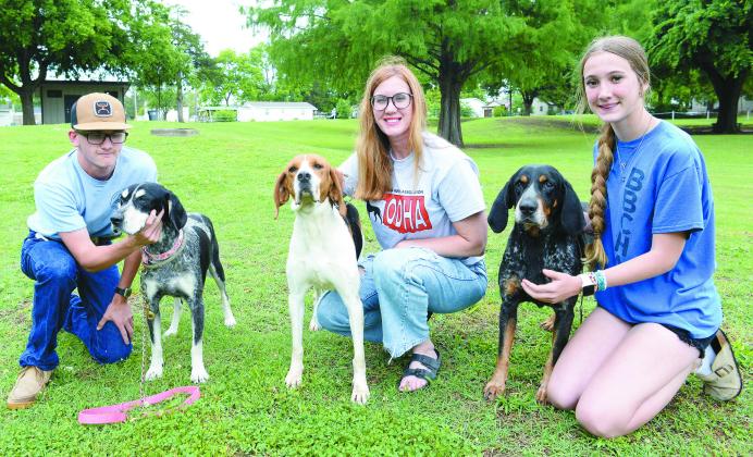 Jerri Loveland, center, poses with her dog, Gemma; her son Cole and his dog, Lucy; and her daughter Ryleigh with JJ. Photo/Brian Blansett