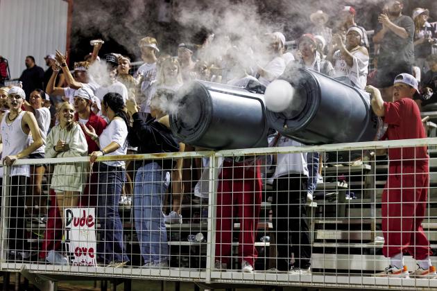 Prague pummeled Class SAS Friday night in the season opener, with the student body provided the mataphor with trash can smoke ring cannns, above. Below, Jaxon Smith (58) sacks the quarterback. Bottom left, Clay LaValley bobs and weaves for a big gain. Below right, The cheer squad and players celebrated on the field after the game.Bottom right, Nolan Yates (2) breaks into the open and is on his way to the endzone. Photos/Rick Hester
