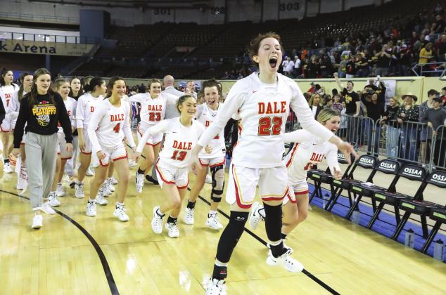 Above, Brook Rutland leads the Lady pirates off the court following their firstround win over Silo. Right, Faith Wright holds a jumbo check for a scholarship for Dale after winning a three-point shooting contest and setting a new record. Photo/Rick Hester