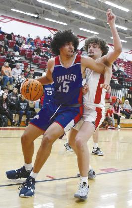 Right, Zalen Smith (15) pounds the lane against the defense of McLoud’s Castin Schafer (11) during their regular season finale Monday. Photo/Brian Blansett