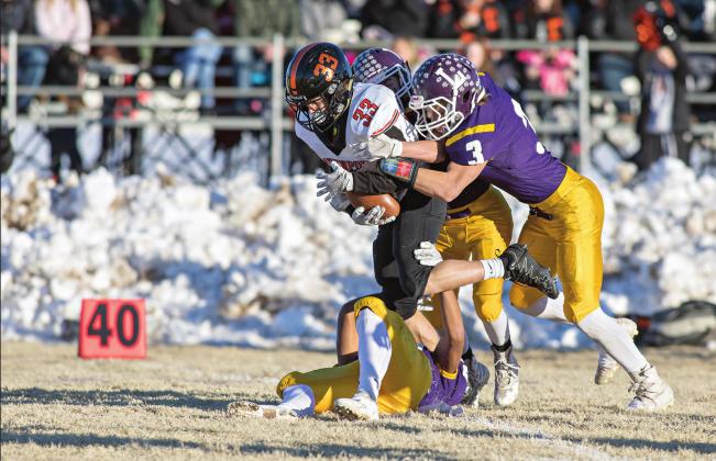 Davenport’s Colton VanFossen (33) picks up some yards for the Bulldogs before being tackled by Peyton Freeman (3) and his associates. Photo/ Rick Hester.