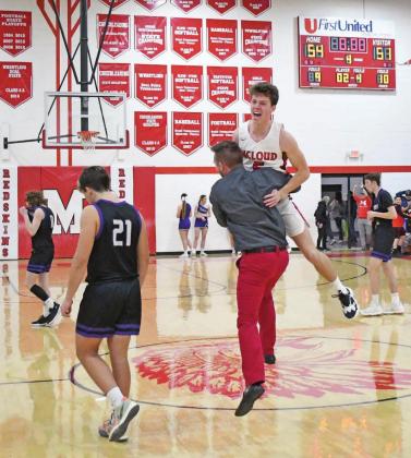 McLoud coach Tim Boyer hoists Coby Cardin after the final buzzer in McLoud’s overtime win over Bethany Friday night. Photo/Brian Blansett